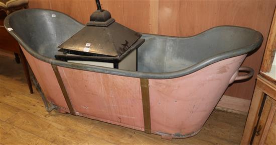 A roll top bath, pink painted sides W.198cm